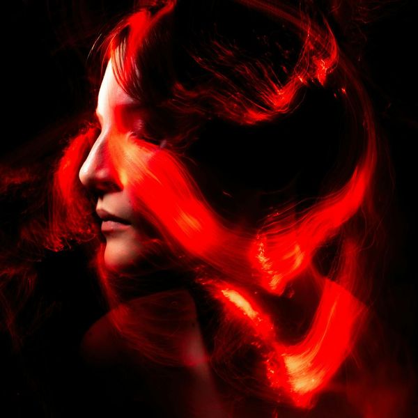 Silhouette of a person stretching against a dark background with light blue accents.
