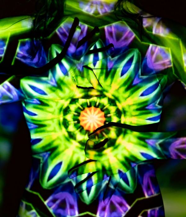 Woman in a calm yoga pose, surrounded by a serene purple and light blue aura.